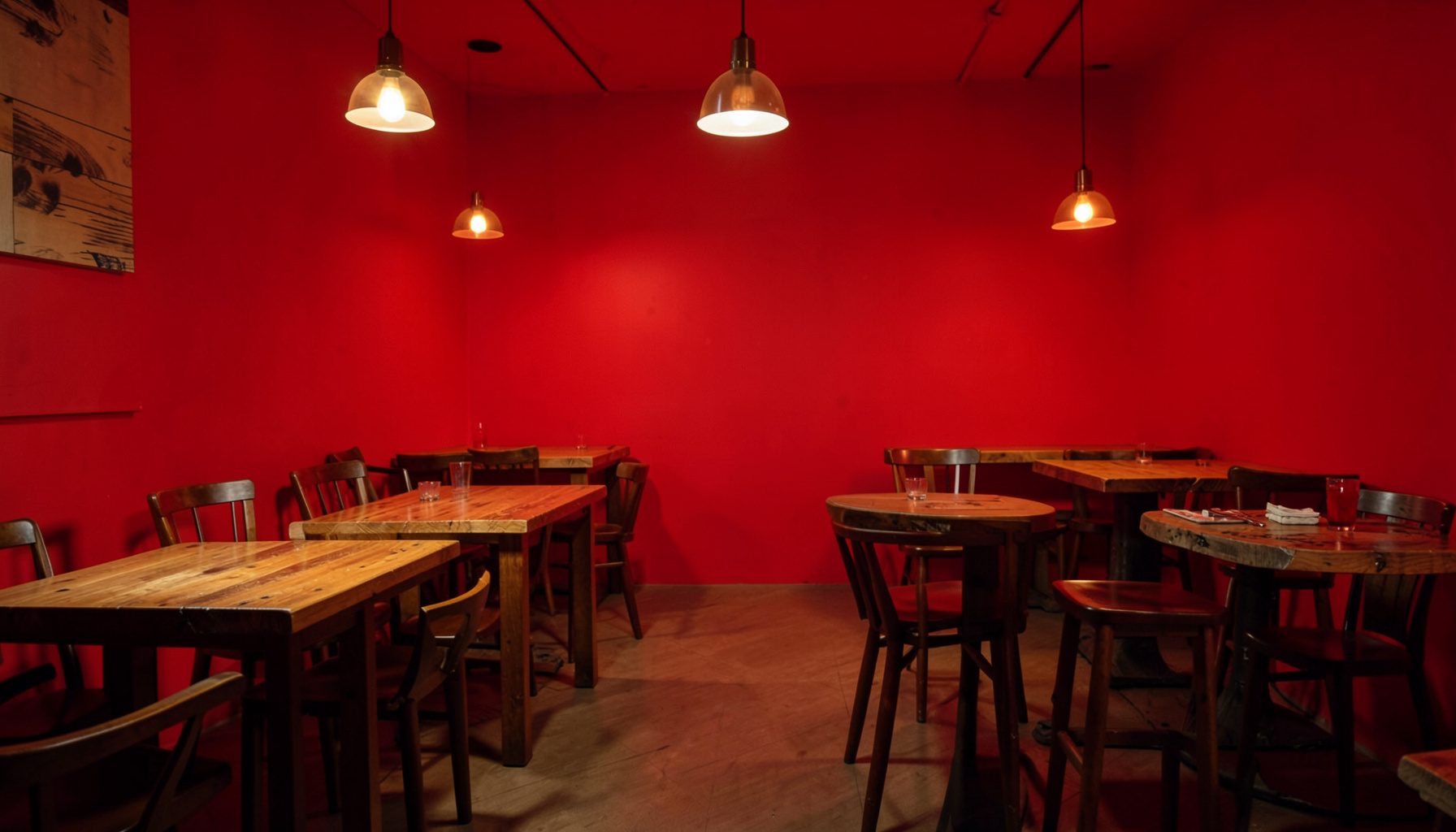Warm interior of a barbecue restaurant with wooden tables and soft amber lighting, inviting and relaxed atmosphere