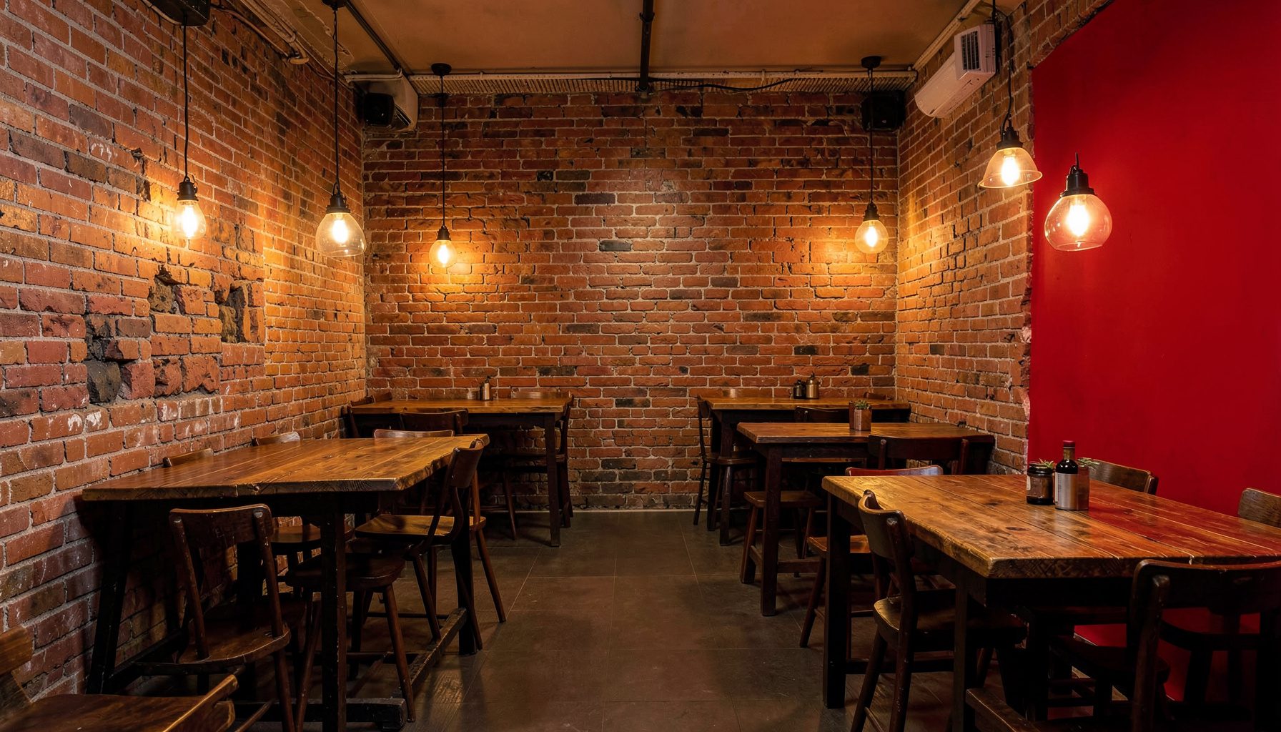 Warm, rustic barbecue restaurant interior with exposed brick walls, wooden tables, and soft amber lighting creating a welcoming Southern atmosphere.
